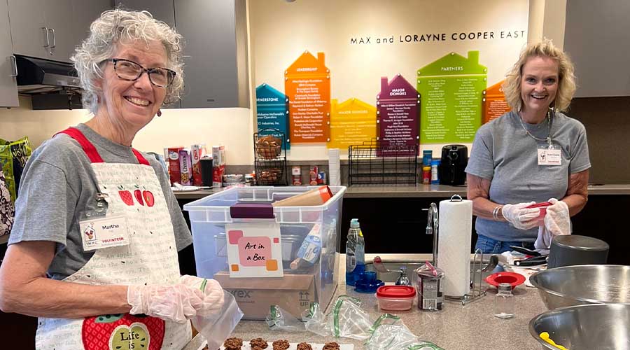 Two volunteers baking in the kitchen