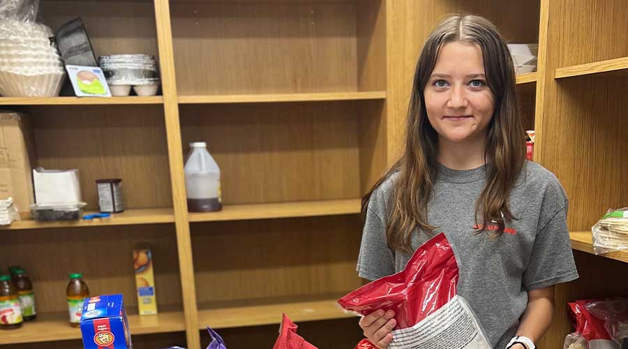 A volunteer organizes shelves