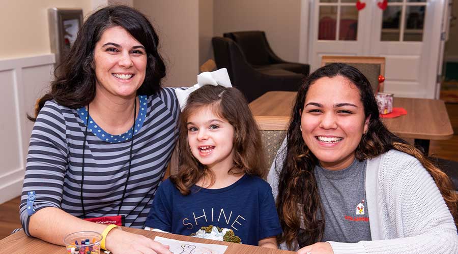 A mom, her child and an RMHC of Alabama volunteer