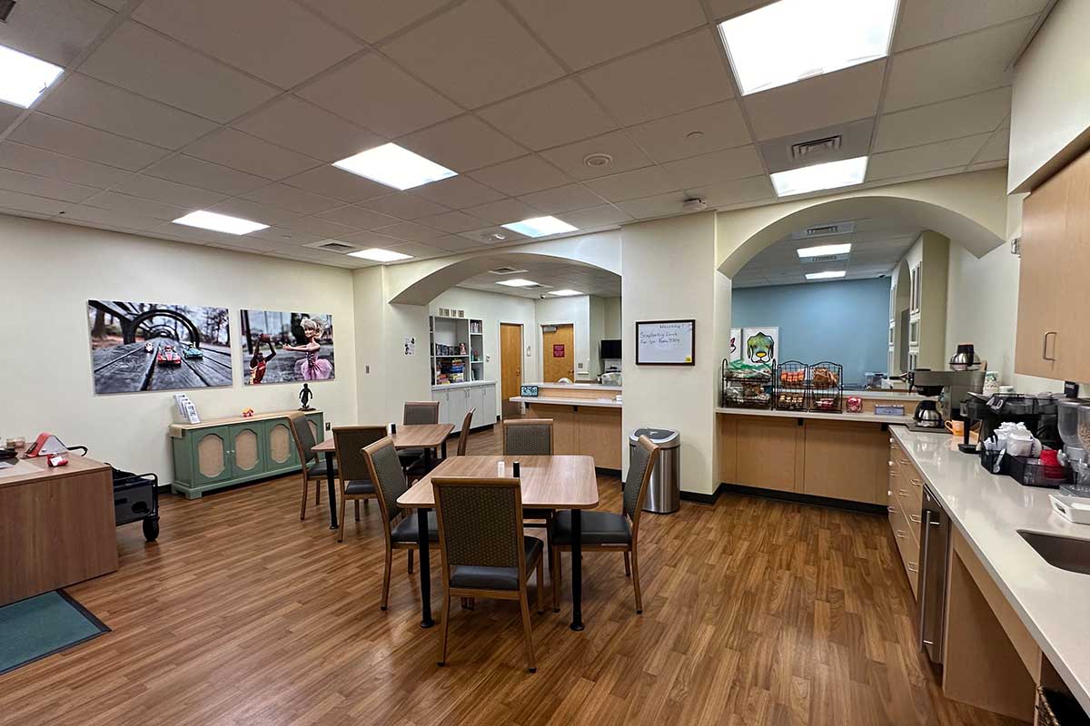 An open area with tables and art on the wall