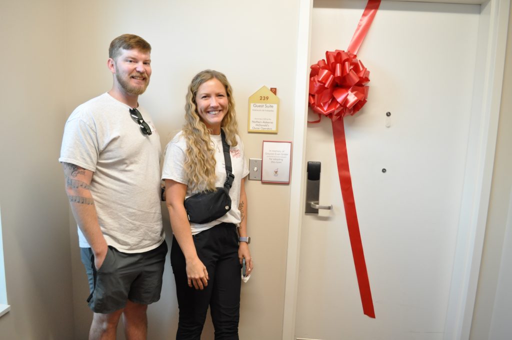 Grayson's parents stand beside their Adopt a Room
