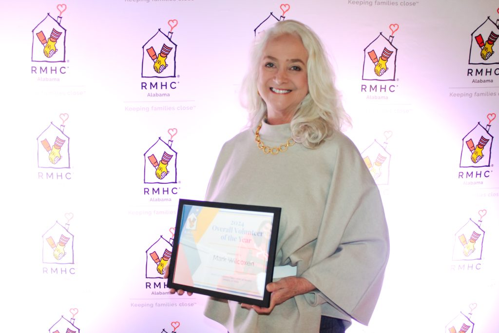 A woman holds an award