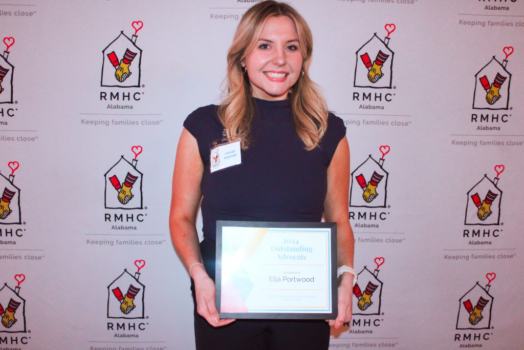 A woman holds an award
