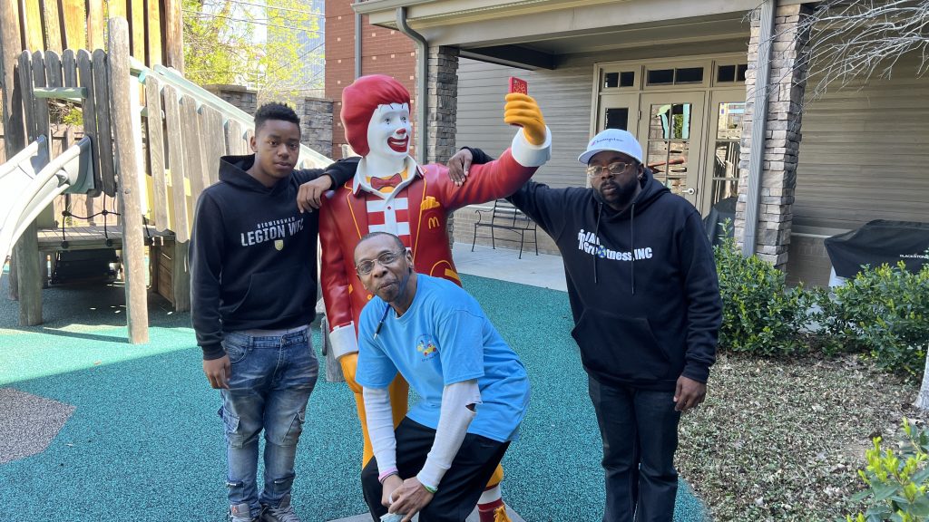 3 men pose for a photo