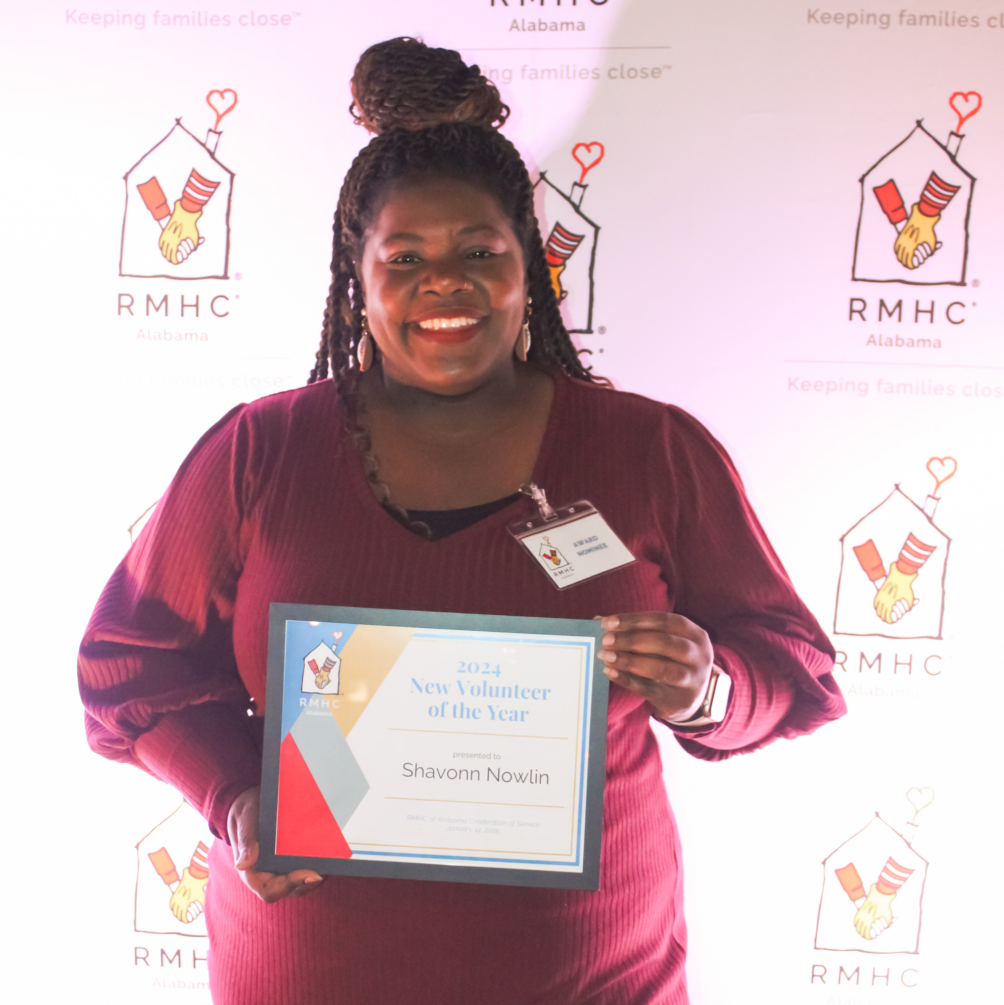 A woman holds an award